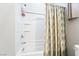 Bright white shower with handy built-in shelves and a stylish patterned shower curtain at 357 S Milan St, Henderson, NV 89015