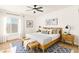 Staged bedroom with a queen-sized bed, stylish decor, and a ceiling fan at 3668 Villa Knolls East Dr, Las Vegas, NV 89120