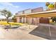 Exterior view of the townhouse with covered parking, showcasing the building's architecture and landscaping at 3668 Villa Knolls East Dr, Las Vegas, NV 89120