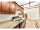 Bright kitchen featuring granite countertops, plenty of cabinet space, and essential appliances at 3668 Villa Knolls East Dr, Las Vegas, NV 89120