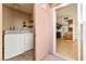 The laundry room features a washer and dryer, with access to the side patio and views of the kitchen at 3668 Villa Knolls East Dr, Las Vegas, NV 89120