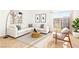 Bright living room with a neutral color palette, a large sectional, and a sliding glass door to the patio at 3668 Villa Knolls East Dr, Las Vegas, NV 89120