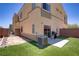 Large backyard featuring artificial grass, a patio, and privacy walls at 4020 Smokey Fog Ave # 3, North Las Vegas, NV 89081