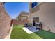 Private backyard featuring artificial grass, a patio, and a gas barbecue grill at 4020 Smokey Fog Ave # 3, North Las Vegas, NV 89081