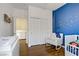 Bedroom featuring a crib, rocking chair, and closet and a doorway at 4020 Smokey Fog Ave # 3, North Las Vegas, NV 89081