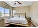 Bright bedroom featuring a ceiling fan, wood flooring, and view of the surrounding landscape at 4020 Smokey Fog Ave # 3, North Las Vegas, NV 89081
