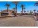 Gated Black Hawk community entrance with lush landscaping, palm trees, and controlled access at 4020 Smokey Fog Ave # 3, North Las Vegas, NV 89081