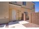Home featuring a white front door with a small gravel entryway and a light tan stucco exterior at 4020 Smokey Fog Ave # 3, North Las Vegas, NV 89081