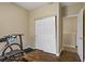 Exercise room with wood floors, exercise bike, exercise bench, weights and closet at 4020 Smokey Fog Ave # 3, North Las Vegas, NV 89081