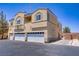 A building with a three-car garage has a textured exterior and a neatly paved driveway at 4020 Smokey Fog Ave # 3, North Las Vegas, NV 89081