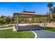 A covered gazebo with picnic tables is surrounded by trees and manicured landscaping at 4020 Smokey Fog Ave # 3, North Las Vegas, NV 89081