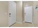 Tiled hallway featuring two white doors with matching hardware and light tan walls at 4020 Smokey Fog Ave # 3, North Las Vegas, NV 89081