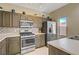Well-lit kitchen features stainless steel appliances, tile backsplash and neutral countertops at 4020 Smokey Fog Ave # 3, North Las Vegas, NV 89081