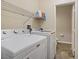Functional laundry room with washer, dryer, utility sink, storage and easy access to the adjacent powder room at 4020 Smokey Fog Ave # 3, North Las Vegas, NV 89081
