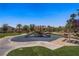 A playground with slides and climbing frames is surrounded by picnic tables and landscaping at 4020 Smokey Fog Ave # 3, North Las Vegas, NV 89081