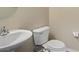 Convenient powder room features a pedestal sink, toilet and neutral walls at 4020 Smokey Fog Ave # 3, North Las Vegas, NV 89081