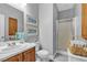 Bathroom featuring wood vanity, framed sailboat prints and glass enclosed shower at 4435 Peaceful Harbor St, Las Vegas, NV 89129