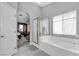 Bright bathroom with a separate shower and tub and an arched doorway to the bedroom at 4435 Peaceful Harbor St, Las Vegas, NV 89129