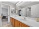 Bathroom featuring double sinks, neutral walls, and views to another bedroom in the house at 4435 Peaceful Harbor St, Las Vegas, NV 89129