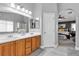 Bathroom with double sinks, granite counters, and an adjoining bedroom and shower at 4435 Peaceful Harbor St, Las Vegas, NV 89129
