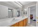 Bathroom featuring double sinks, neutral walls, and views to another bedroom in the house at 4435 Peaceful Harbor St, Las Vegas, NV 89129