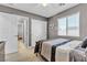 Inviting bedroom features carpet, closet, ceiling fan, and a window with a view of the roof at 4435 Peaceful Harbor St, Las Vegas, NV 89129