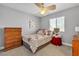 Comfortable bedroom features neutral walls, carpet flooring, and window overlooking a dark brown dresser at 4435 Peaceful Harbor St, Las Vegas, NV 89129