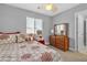 Comfortable bedroom features neutral walls, carpet flooring, and window overlooking a dark brown dresser at 4435 Peaceful Harbor St, Las Vegas, NV 89129