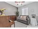Cozy bedroom with piano, grey walls, comfortable sofa, and ample natural light at 4435 Peaceful Harbor St, Las Vegas, NV 89129