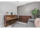 Cozy bedroom with piano, grey walls, comfortable sofa, and ample natural light at 4435 Peaceful Harbor St, Las Vegas, NV 89129