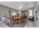 Formal dining room featuring an oversized wood table, eight chairs, and display cabinet at 4435 Peaceful Harbor St, Las Vegas, NV 89129