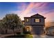 Charming two-story home at twilight with a well-manicured lawn and flowering tree at 4435 Peaceful Harbor St, Las Vegas, NV 89129