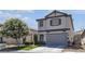 Charming two-story home with a well-manicured lawn and mature flowering tree at 4435 Peaceful Harbor St, Las Vegas, NV 89129