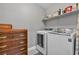 Laundry area with front load washer, dryer, and ample storage space at 4435 Peaceful Harbor St, Las Vegas, NV 89129