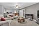 Large living area with neutral decor, ceiling fan, and access to a second floor at 4435 Peaceful Harbor St, Las Vegas, NV 89129