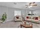 Cozy living room featuring neutral walls, carpet flooring, an ceiling fan with upholstered chair and sofa at 4435 Peaceful Harbor St, Las Vegas, NV 89129