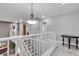 Upstairs landing with neutral colors and an ornate chandelier at 4435 Peaceful Harbor St, Las Vegas, NV 89129