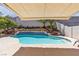 Backyard oasis featuring a swimming pool with a waterfall feature and desert landscaping at 4435 Peaceful Harbor St, Las Vegas, NV 89129