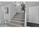 Carpeted staircase leading to the upper level with a view of the front door at 4435 Peaceful Harbor St, Las Vegas, NV 89129