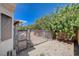 Low-maintenance backyard featuring a fence, gravel, and perimeter of mature landscaping at 4612 Standing Bluff Way, Las Vegas, NV 89130