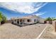 Expansive backyard featuring neutral rock landscaping and a covered patio at 4612 Standing Bluff Way, Las Vegas, NV 89130