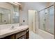 Bathroom with double sinks, tiled countertops, and a glass shower at 4612 Standing Bluff Way, Las Vegas, NV 89130