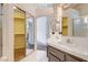 Bathroom featuring dual sinks, mirrored closet, and tiled shower at 4612 Standing Bluff Way, Las Vegas, NV 89130