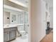 The renovated bathroom features modern gray cabinets, a toilet, and a shower with glass doors at 4612 Standing Bluff Way, Las Vegas, NV 89130