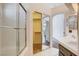 Bathroom featuring tiled shower, closet, and dual sinks at 4612 Standing Bluff Way, Las Vegas, NV 89130