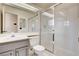 The bathroom features a toilet, sink, large mirror and shower with sliding glass doors at 4612 Standing Bluff Way, Las Vegas, NV 89130