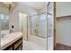 Bathroom featuring double sinks, tiled shower with glass door, and a closet at 4612 Standing Bluff Way, Las Vegas, NV 89130