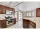 A well-lit kitchen with dark cabinets and stainless steel appliances at 4612 Standing Bluff Way, Las Vegas, NV 89130