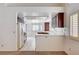 Kitchen with white appliances and dark wooden cabinets, white countertops and floors at 4612 Standing Bluff Way, Las Vegas, NV 89130