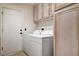 The laundry room features a washer, dryer, closet and door to exit to outside at 4612 Standing Bluff Way, Las Vegas, NV 89130